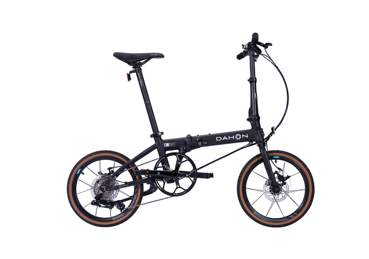 Dahon K9 DELTECH folding bike, black, with tan tires for urban travel.